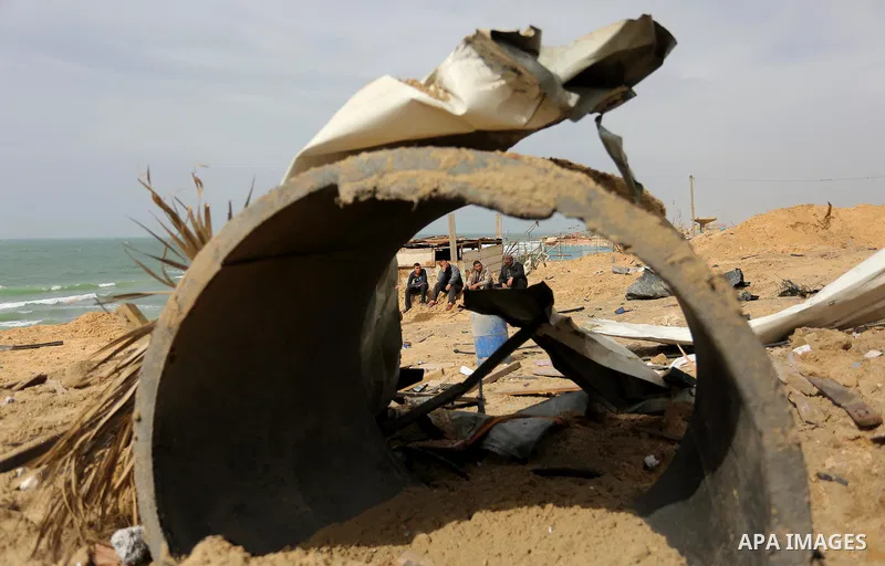 Palestinians inspect the scene of what Gaza police said was an Israeli air strike in Beit Lahia in the northern of Gaza Strip, on March 18, 2017. A rocket fired by Palestinians in the Gaza Strip slammed into southern Isr...