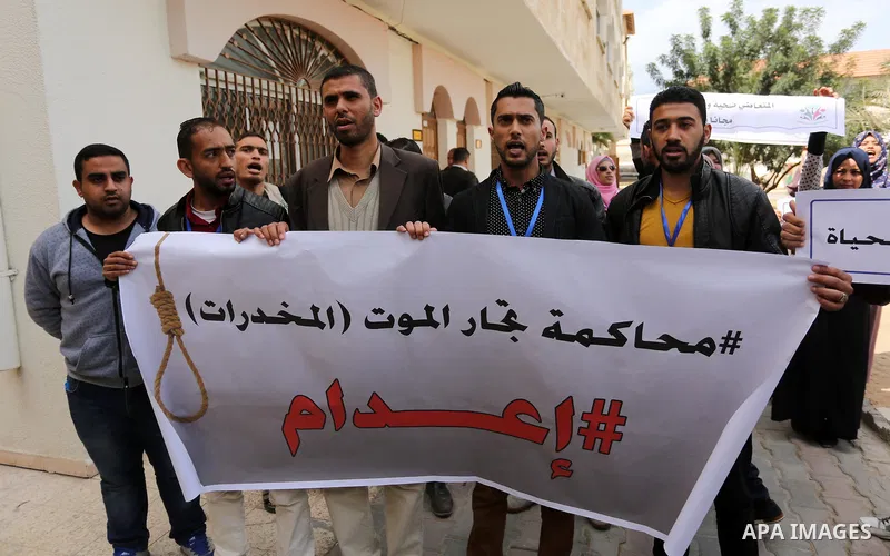 Palestinians hold banners during a protest demanding to prosecution anti-drug traders in Gaza City on March 19, 2017. Destroying the collected drugs was part of a new campaign by Hamas-run police to combat the usage of d...
