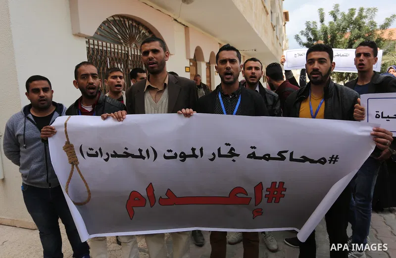 Palestinians hold banners during a protest demanding to prosecution anti-drug traders in Gaza City on March 19, 2017. Destroying the collected drugs was part of a new campaign by Hamas-run police to combat the usage of d...
