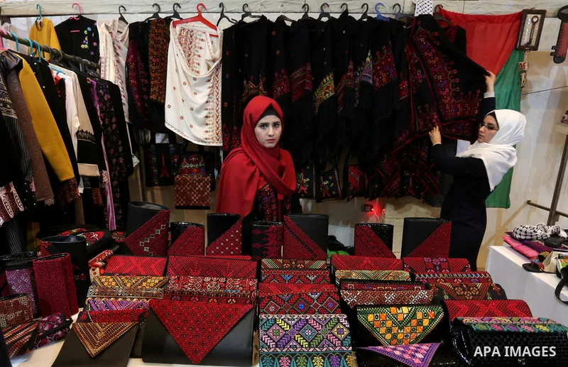 Palestinian women take part during Palestinian Heritage Exhibition on the theme ''Products of our women'', in Gaza City, on March 19, 2017. Photo by Ashraf Amra