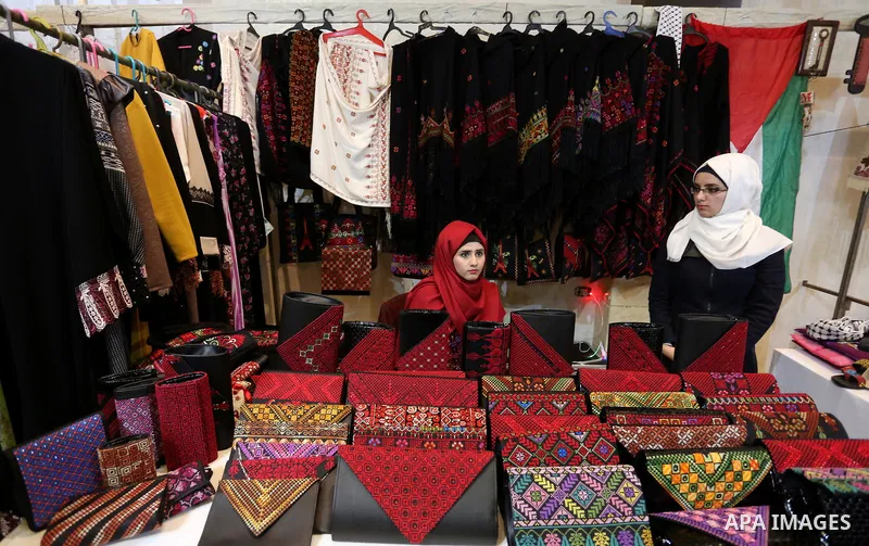 Palestinian women take part during Palestinian Heritage Exhibition on the theme ''Products of our women'', in Gaza City, on March 19, 2017. Photo by Ashraf Amra
