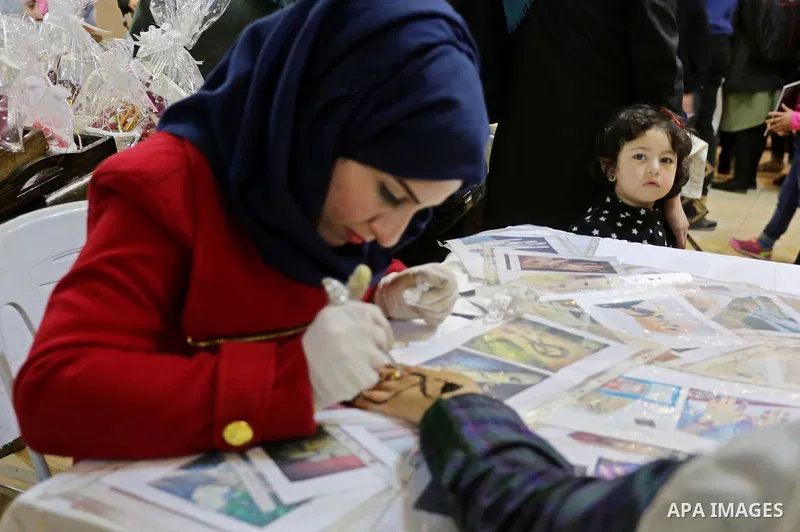 Palestinian women take part during Palestinian Heritage Exhibition on the theme ''Products of our women'', in Gaza City, on March 19, 2017. Photo by Ashraf Amra