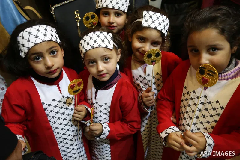 Palestinian women take part during Palestinian Heritage Exhibition on the theme ''Products of our women'', in Gaza City, on March 19, 2017. Photo by Ashraf Amra