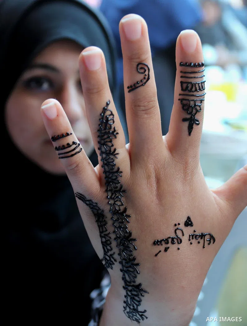 Palestinian women take part during Palestinian Heritage Exhibition on the theme ''Products of our women'', in Gaza City, on March 19, 2017. Photo by Ashraf Amra