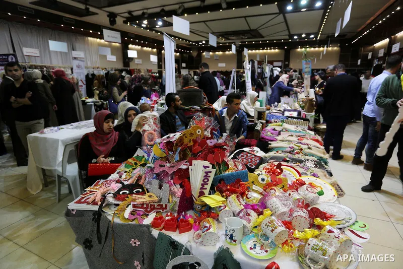 Palestinian women take part during Palestinian Heritage Exhibition on the theme ''Products of our women'', in Gaza City, on March 19, 2017. Photo by Ashraf Amra