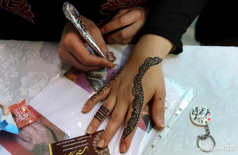 Palestinian women take part during Palestinian Heritage Exhibition on the theme ''Products of our women'', in Gaza City, on March 19, 2017. Photo by Ashraf Amra
