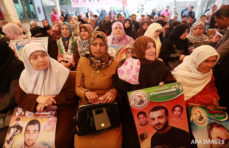 Palestinians hold placards during a protest to show solidarity with Palestinian prisoners held in Israeli Jails, in front of Red cross office in Gaza city, on March 20, 2017. Photo by Mohammed Asad