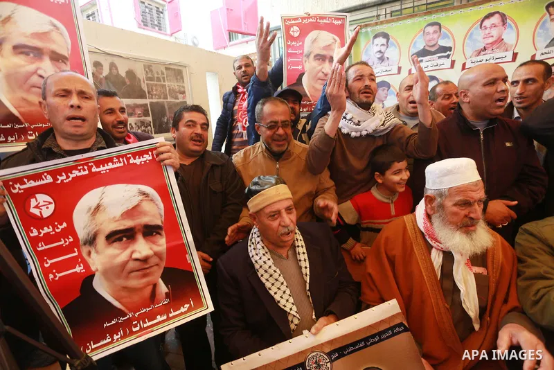 Palestinians hold placards during a protest to show solidarity with Palestinian prisoners held in Israeli Jails, in front of Red cross office in Gaza city, on March 20, 2017. Photo by Mohammed Asad