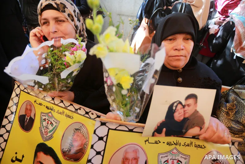Palestinians hold placards during a protest to show solidarity with Palestinian prisoners held in Israeli Jails, in front of Red cross office in Gaza city, on March 20, 2017. Photo by Mohammed Asad