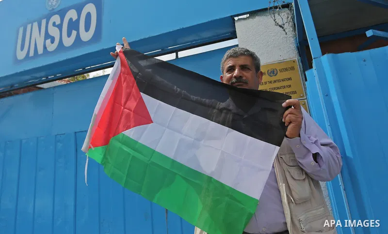 Palestinians hold banners during a protest against the U.N. Secretary-General Antonio Guterres decision to remove Israeli 'apartheid' report from Economic and Social Commission for Western Asia (ESCWA) website, in front...
