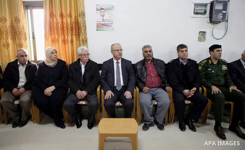 Palestinian Prime Minister Rami Hamdallah offers condolences to the family of Palestinian security officer Hasan Abu Alhaj who was killed during clashes in a raid to arrest a gunman, in the West Bank city of Ramallah on...