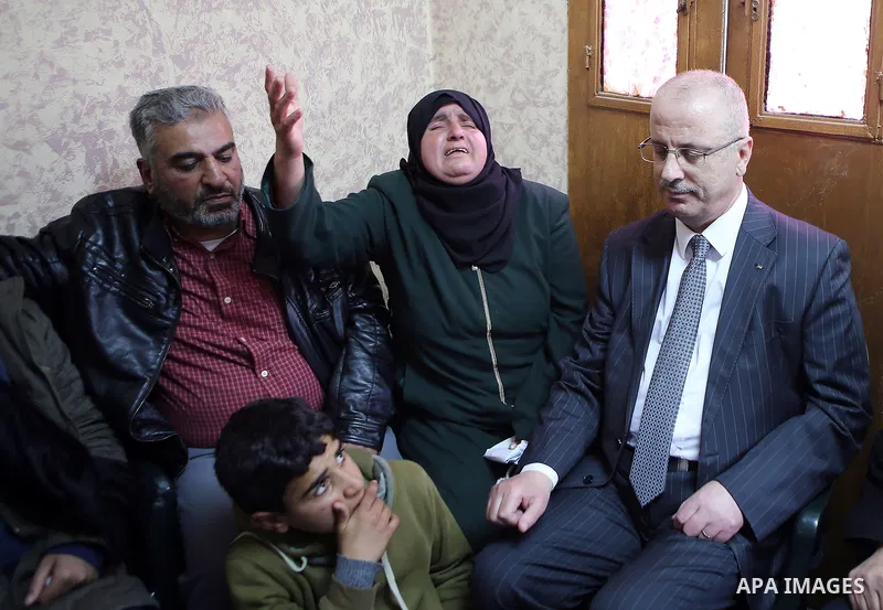Palestinian Prime Minister Rami Hamdallah offers condolences to the family of Palestinian security officer Hasan Abu Alhaj who was killed during clashes in a raid to arrest a gunman, in the West Bank city of Ramallah on...