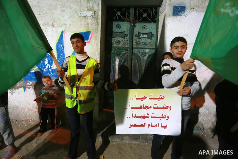 Palestinians take part in a memorial service marking the thirteenth anniversary of the death of late Hamas leader Sheikh Ahmed Yassin, who was killed in an Israeli attack in front of his house in Gaza City, March 21, 201...