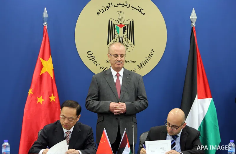 Palestinian Prime Minister Rami Hamdallah, attends the signing of an agreement to receive a grant of electronic equipment from the People's Republic of China, in the West Bank city of Ramallah on March 22, 2017. Photo by...