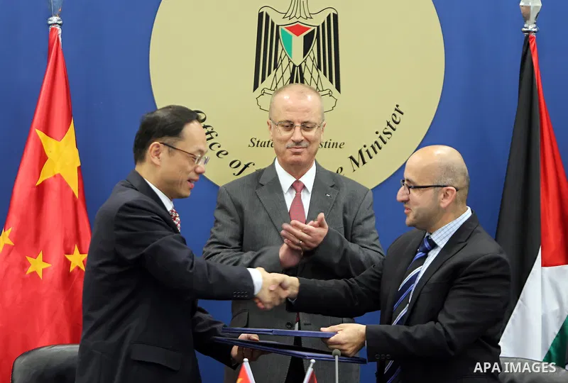 Palestinian Prime Minister Rami Hamdallah, attends the signing of an agreement to receive a grant of electronic equipment from the People's Republic of China, in the West Bank city of Ramallah on March 22, 2017. Photo by...