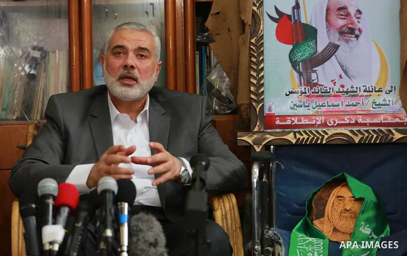 Senior Hamas leader Ismail Haniya, and leader of Hamas in the Gaza Strip, Yahya Sinwar, visit the family of late Hamas leader Sheikh Ahmed Yassin, who was killed in an Israeli attack marking the thirteenth anniversary of...