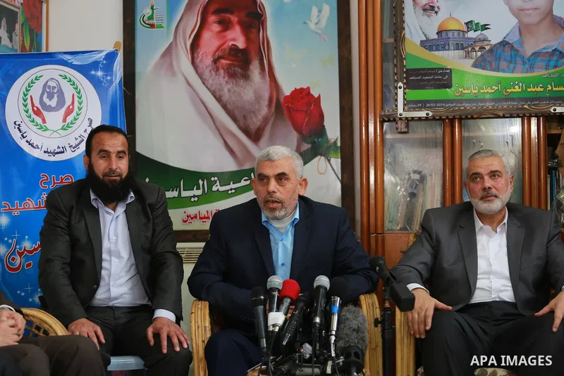 Senior Hamas leader Ismail Haniya, and leader of Hamas in the Gaza Strip, Yahya Sinwar, visit the family of late Hamas leader Sheikh Ahmed Yassin, who was killed in an Israeli attack marking the thirteenth anniversary of...