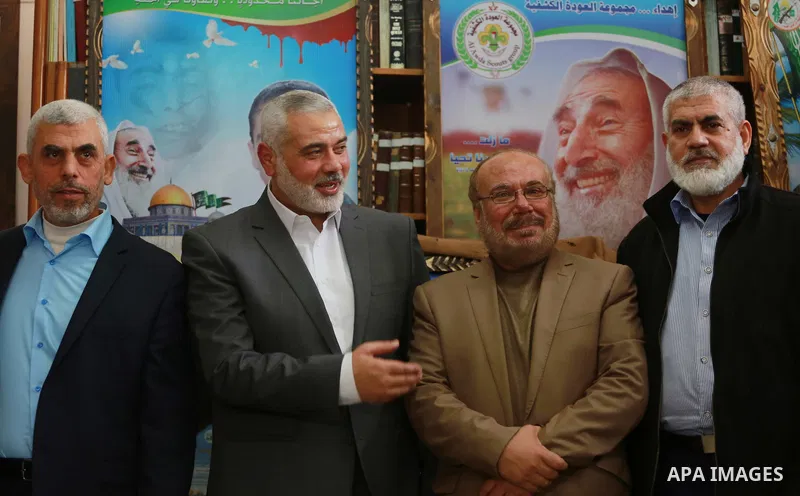 Senior Hamas leader Ismail Haniya, and leader of Hamas in the Gaza Strip, Yahya Sinwar, visit the family of late Hamas leader Sheikh Ahmed Yassin, who was killed in an Israeli attack marking the thirteenth anniversary of...