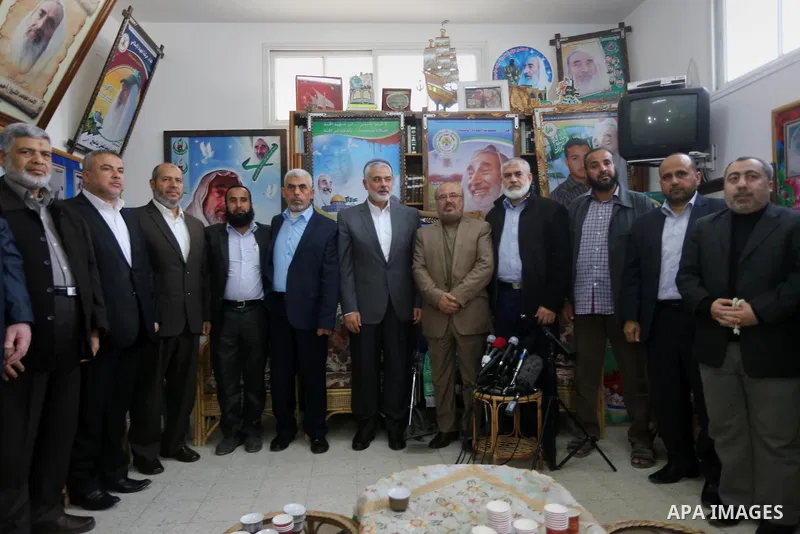 Senior Hamas leader Ismail Haniya, and leader of Hamas in the Gaza Strip, Yahya Sinwar, visit the family of late Hamas leader Sheikh Ahmed Yassin, who was killed in an Israeli attack marking the thirteenth anniversary of...