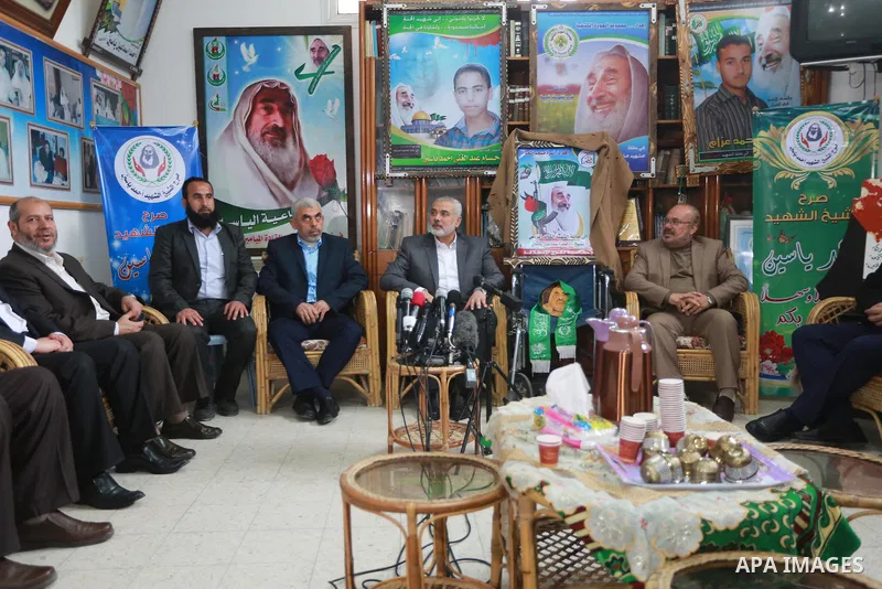 Senior Hamas leader Ismail Haniya, and leader of Hamas in the Gaza Strip, Yahya Sinwar, visit the family of late Hamas leader Sheikh Ahmed Yassin, who was killed in an Israeli attack marking the thirteenth anniversary of...