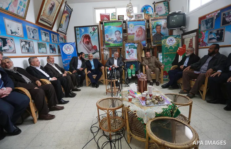 Senior Hamas leader Ismail Haniya, and leader of Hamas in the Gaza Strip, Yahya Sinwar, visit the family of late Hamas leader Sheikh Ahmed Yassin, who was killed in an Israeli attack marking the thirteenth anniversary of...