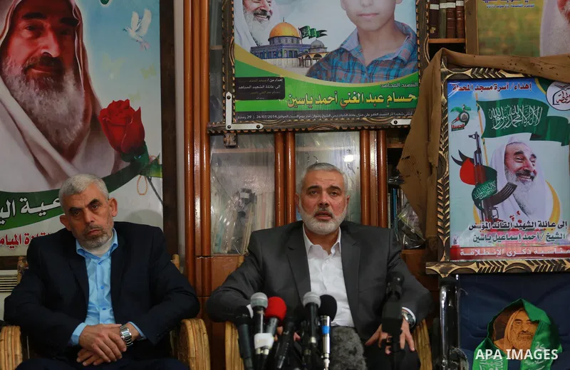 Senior Hamas leader Ismail Haniya, and leader of Hamas in the Gaza Strip, Yahya Sinwar, visit the family of late Hamas leader Sheikh Ahmed Yassin, who was killed in an Israeli attack marking the thirteenth anniversary of...