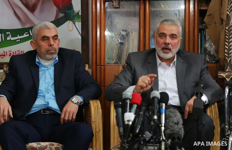 Senior Hamas leader Ismail Haniya, and leader of Hamas in the Gaza Strip, Yahya Sinwar, visit the family of late Hamas leader Sheikh Ahmed Yassin, who was killed in an Israeli attack marking the thirteenth anniversary of...