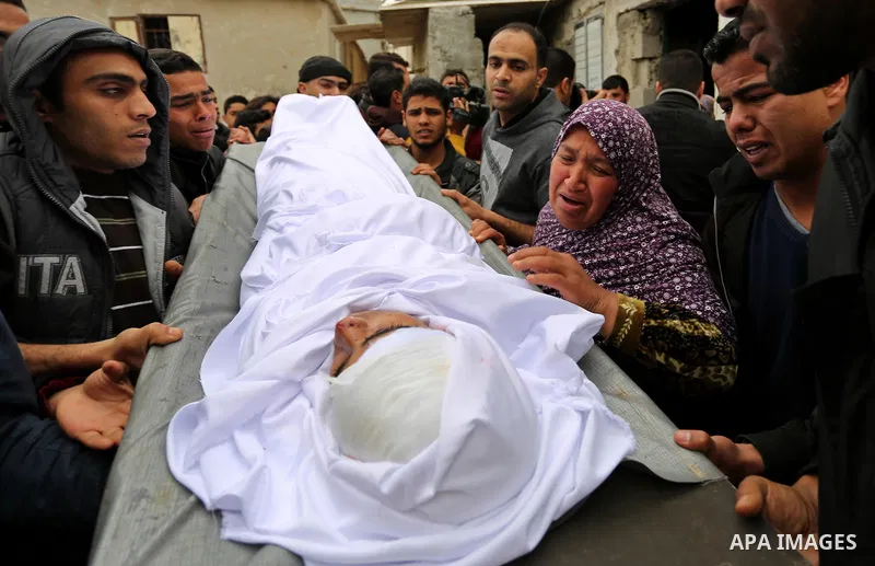 Mourners carry the body of Palestinian Youssef Abu Azra, who according to hospital officials was killed by Israeli fire and whom the Israeli forces said was detected with other suspects near the security fence, during hi...