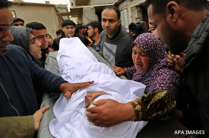 Relatives mourn around the body of Palestinian Youssef Abu Azra, who according to hospital officials was killed by Israeli fire and whom the Israeli forces said was detected with other suspects near the security fence, d...