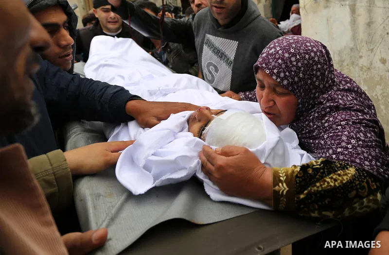 Relatives mourn around the body of Palestinian Youssef Abu Azra, who according to hospital officials was killed by Israeli fire and whom the Israeli forces said was detected with other suspects near the security fence, d...