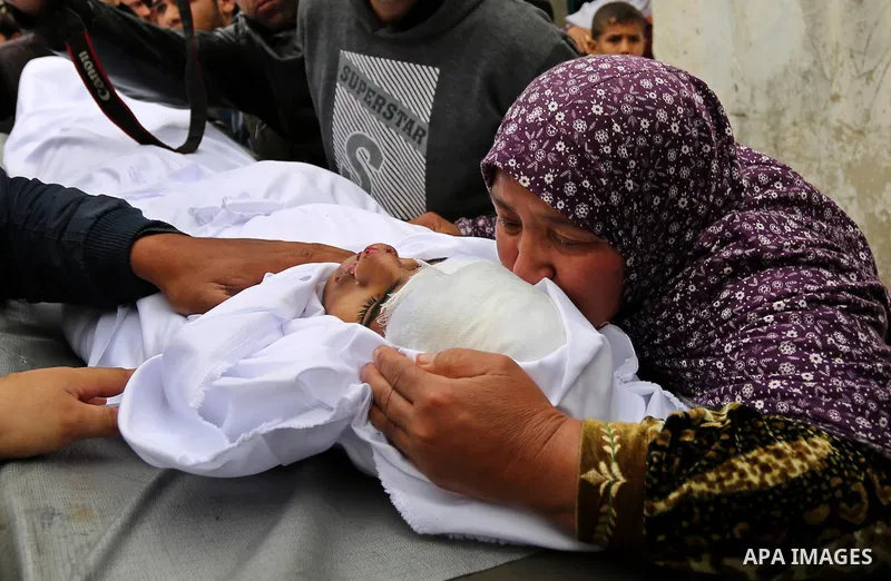 Relatives mourn around the body of Palestinian Youssef Abu Azra, who according to hospital officials was killed by Israeli fire and whom the Israeli forces said was detected with other suspects near the security fence, d...