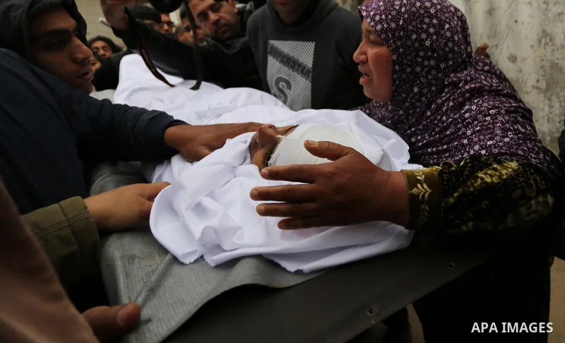 Relatives mourn around the body of Palestinian Youssef Abu Azra, who according to hospital officials was killed by Israeli fire and whom the Israeli forces said was detected with other suspects near the security fence, d...