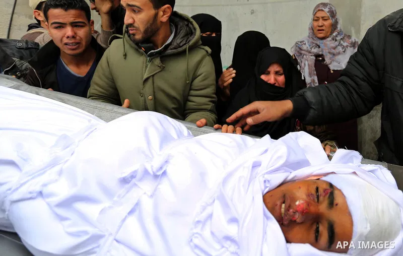 Relatives mourn around the body of Palestinian Youssef Abu Azra, who according to hospital officials was killed by Israeli fire and whom the Israeli forces said was detected with other suspects near the security fence, d...