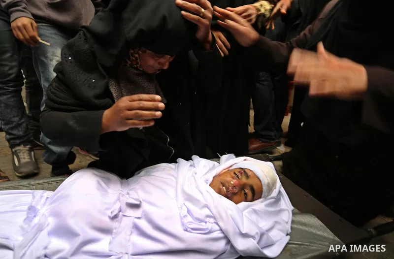 Relatives mourn around the body of Palestinian Youssef Abu Azra, who according to hospital officials was killed by Israeli fire and whom the Israeli forces said was detected with other suspects near the security fence, d...