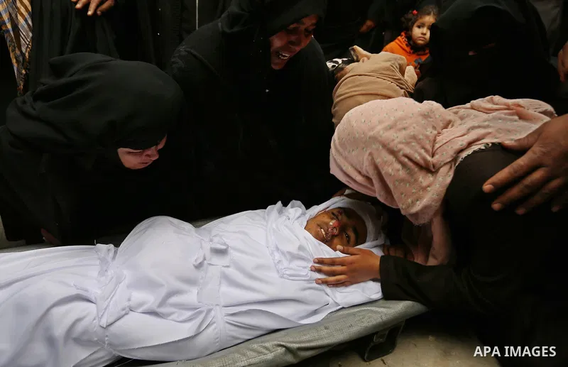 Relatives mourn around the body of Palestinian Youssef Abu Azra, who according to hospital officials was killed by Israeli fire and whom the Israeli forces said was detected with other suspects near the security fence, d...