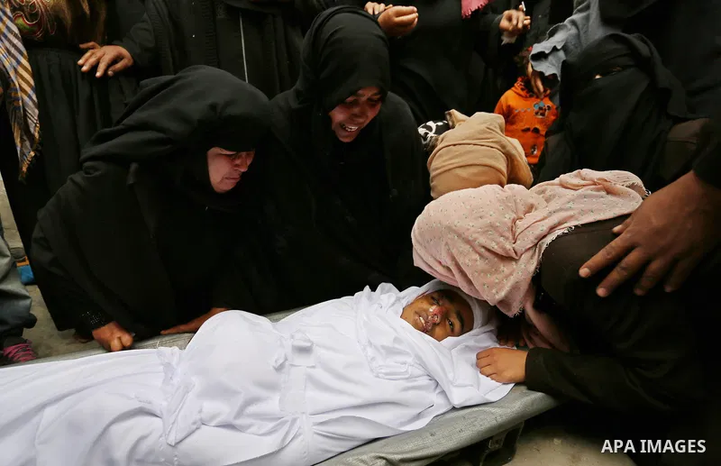 Relatives mourn around the body of Palestinian Youssef Abu Azra, who according to hospital officials was killed by Israeli fire and whom the Israeli forces said was detected with other suspects near the security fence, d...