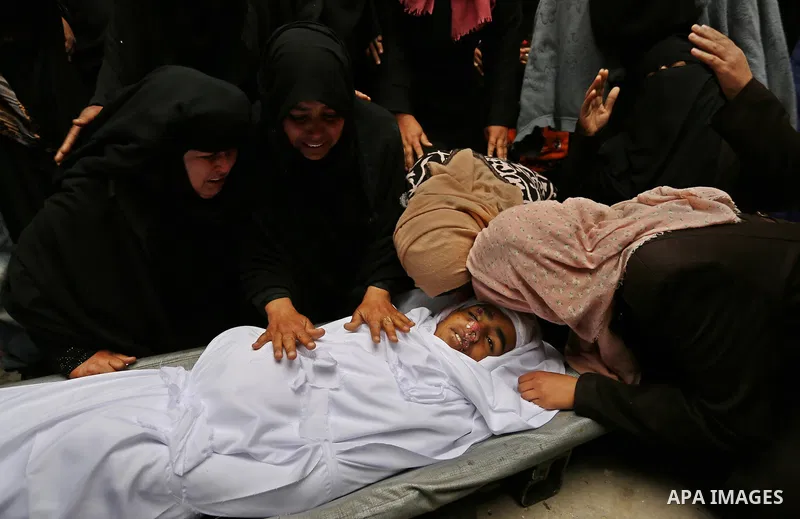 Relatives mourn around the body of Palestinian Youssef Abu Azra, who according to hospital officials was killed by Israeli fire and whom the Israeli forces said was detected with other suspects near the security fence, d...