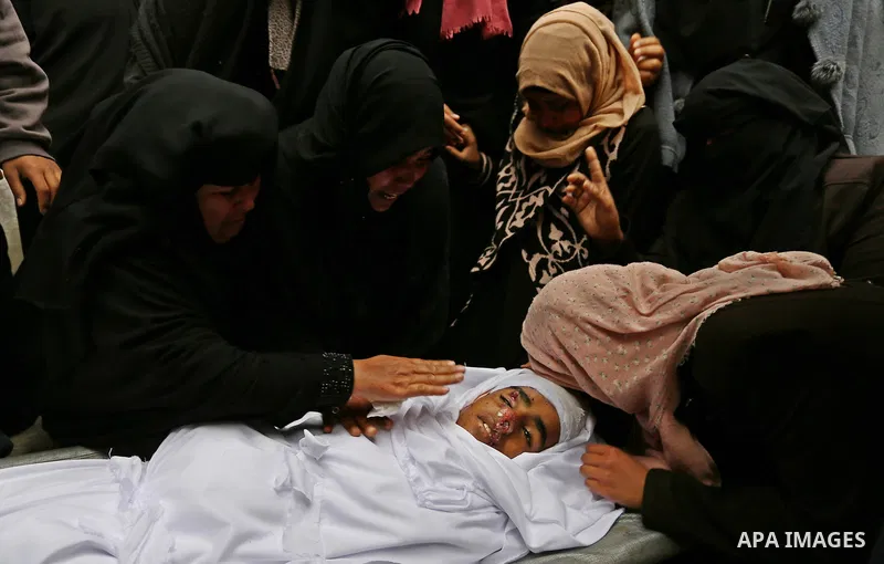 Relatives mourn around the body of Palestinian Youssef Abu Azra, who according to hospital officials was killed by Israeli fire and whom the Israeli forces said was detected with other suspects near the security fence, d...