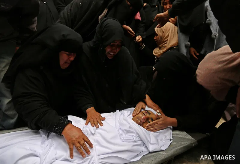 Relatives mourn around the body of Palestinian Youssef Abu Azra, who according to hospital officials was killed by Israeli fire and whom the Israeli forces said was detected with other suspects near the security fence, d...