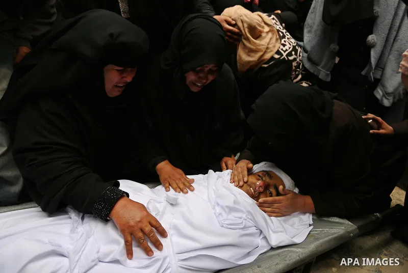Relatives mourn around the body of Palestinian Youssef Abu Azra, who according to hospital officials was killed by Israeli fire and whom the Israeli forces said was detected with other suspects near the security fence, d...