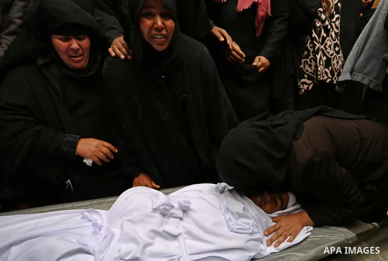 Relatives mourn around the body of Palestinian Youssef Abu Azra, who according to hospital officials was killed by Israeli fire and whom the Israeli forces said was detected with other suspects near the security fence, d...