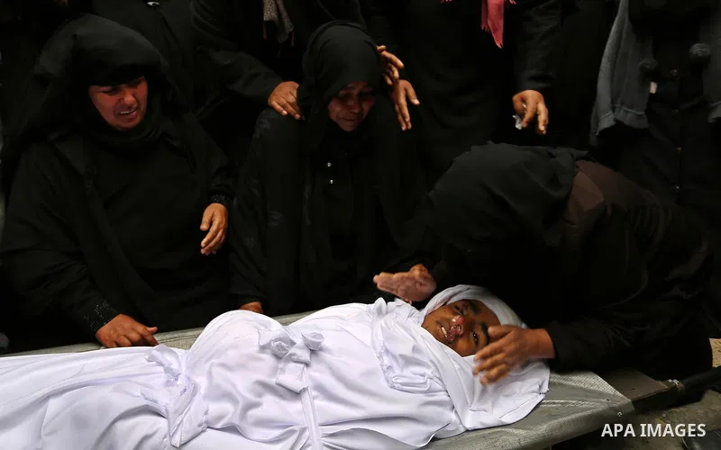 Relatives mourn around the body of Palestinian Youssef Abu Azra, who according to hospital officials was killed by Israeli fire and whom the Israeli forces said was detected with other suspects near the security fence, d...