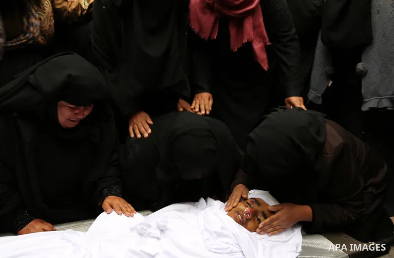Relatives mourn around the body of Palestinian Youssef Abu Azra, who according to hospital officials was killed by Israeli fire and whom the Israeli forces said was detected with other suspects near the security fence, d...