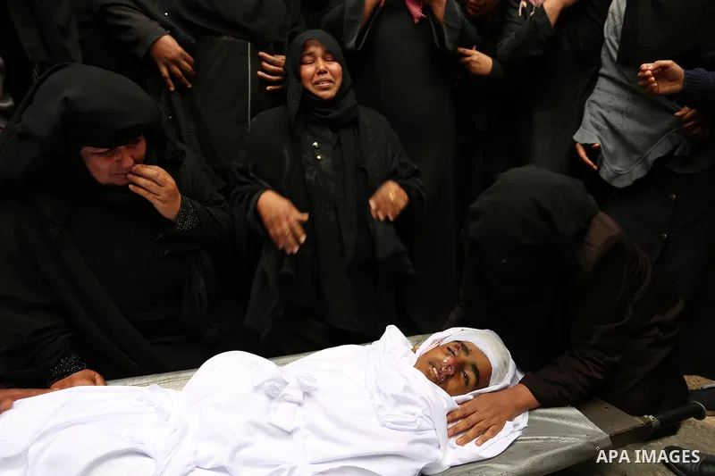 Relatives mourn around the body of Palestinian Youssef Abu Azra, who according to hospital officials was killed by Israeli fire and whom the Israeli forces said was detected with other suspects near the security fence, d...