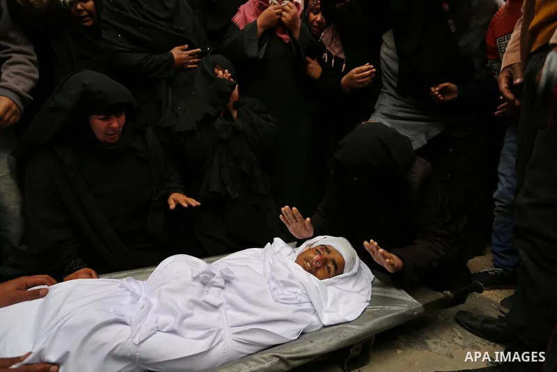 Relatives mourn around the body of Palestinian Youssef Abu Azra, who according to hospital officials was killed by Israeli fire and whom the Israeli forces said was detected with other suspects near the security fence, d...