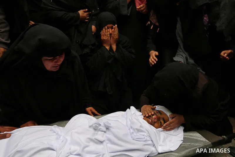 Relatives mourn around the body of Palestinian Youssef Abu Azra, who according to hospital officials was killed by Israeli fire and whom the Israeli forces said was detected with other suspects near the security fence, d...