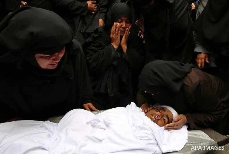 Relatives mourn around the body of Palestinian Youssef Abu Azra, who according to hospital officials was killed by Israeli fire and whom the Israeli forces said was detected with other suspects near the security fence, d...