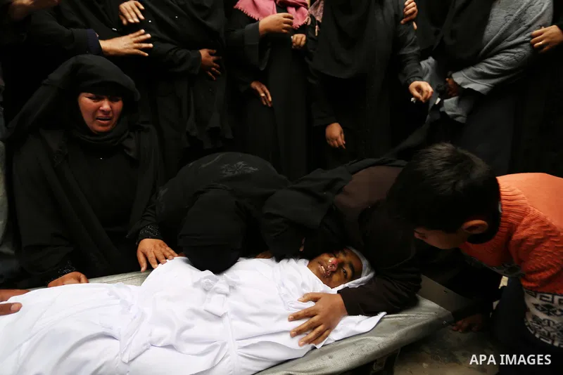 Relatives mourn around the body of Palestinian Youssef Abu Azra, who according to hospital officials was killed by Israeli fire and whom the Israeli forces said was detected with other suspects near the security fence, d...