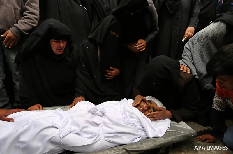 Relatives mourn around the body of Palestinian Youssef Abu Azra, who according to hospital officials was killed by Israeli fire and whom the Israeli forces said was detected with other suspects near the security fence, d...