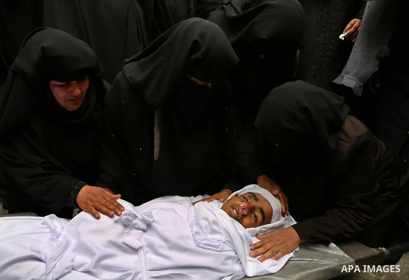 Relatives mourn around the body of Palestinian Youssef Abu Azra, who according to hospital officials was killed by Israeli fire and whom the Israeli forces said was detected with other suspects near the security fence, d...